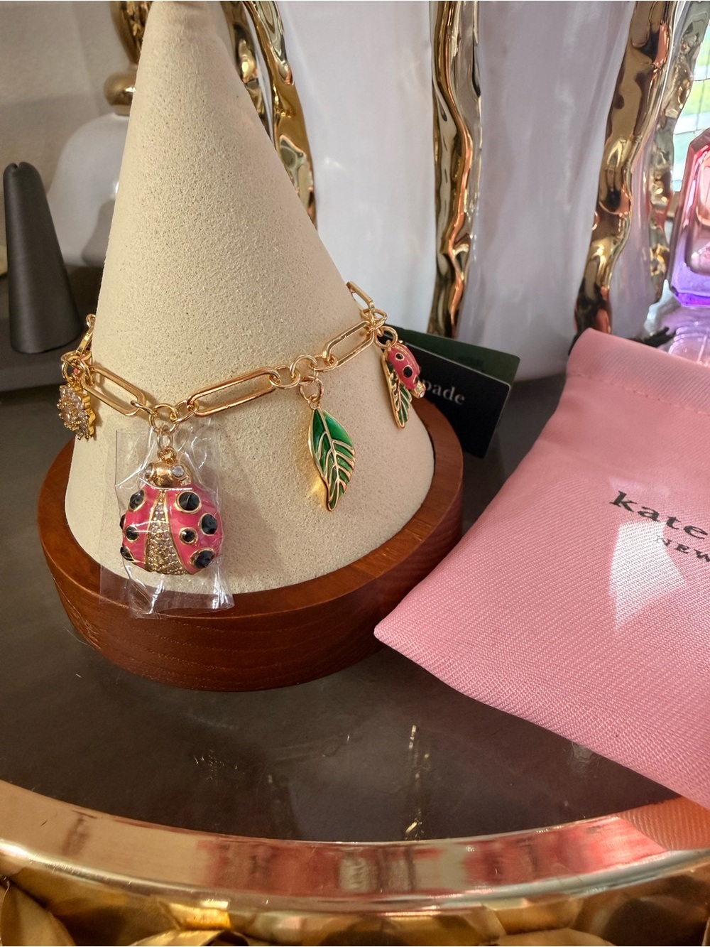 kate spade gold-tone pink ladybug and green leaf charm bracelet